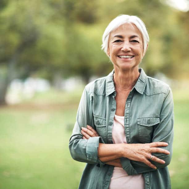Portrait of a happy and confident senior woman standing in the park